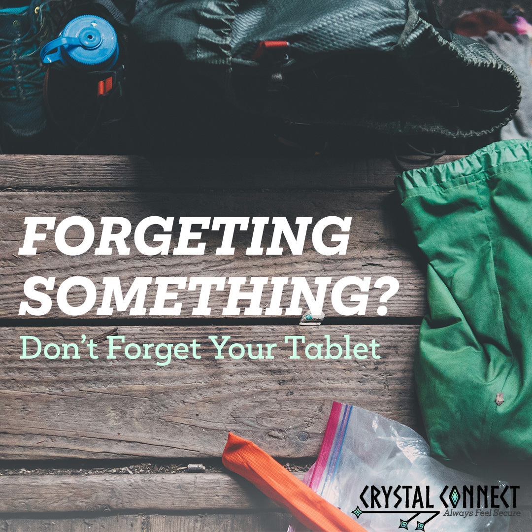 A wooden tabled covered in travel supplies like a backpack and waterbottle. The text says 'Forgetting something? Don't forget your tablet.'